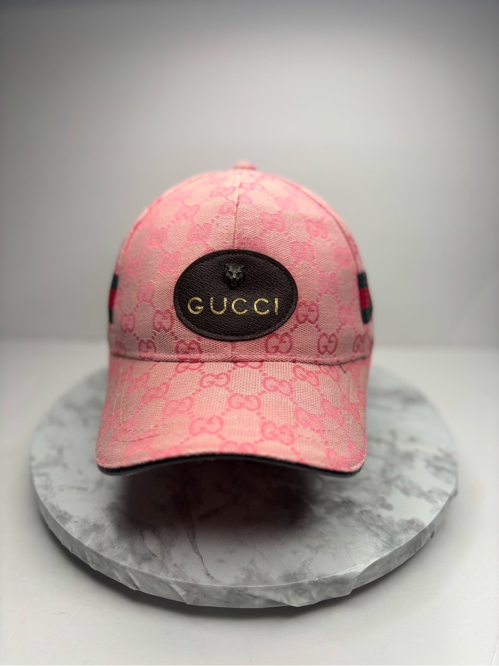 Gucci baseball cap featuring a pink GG monogram canvas and a leather patch